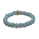 Lava hellblau mit königlichem Mantra Om, Armband elastischer Naturstein, Kugel 8 mm / 16-17 cm, geboren aus den vier Elementen